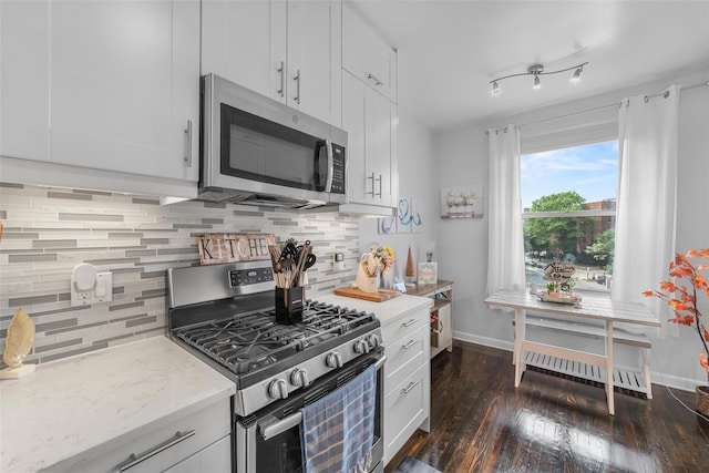 472 Gramatan Ave Unit Dd3, Mount Vernon, NY 10552 - kitchen featuring appliances with stainless steel finishes, white cabinetry, backsplash, dark wood-style flooring, and light stone countertops