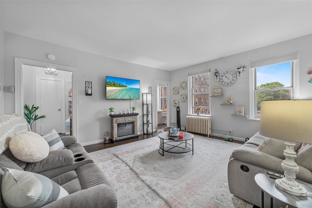 472 Gramatan Ave Unit Dd3, Mount Vernon, NY 10552 - living room with radiator heating unit, a fireplace, a chandelier, and wood finished floors