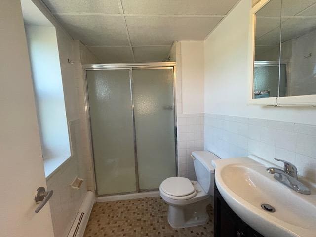 100 Clinton Ave Unit 4T, Mineola, NY 11501 - full bath with a paneled ceiling, vanity, a baseboard heating unit, a stall shower, and toilet