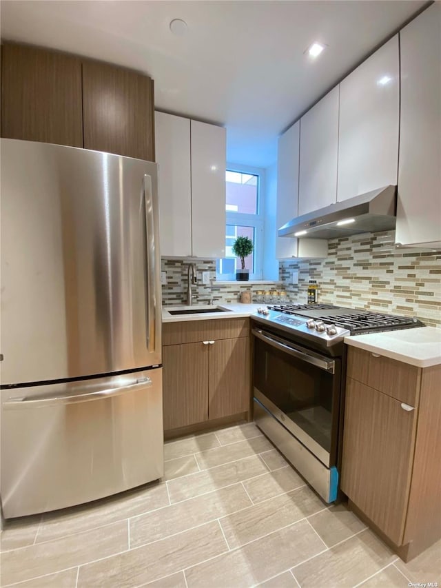 4223 Parsons Blvd Unit 1E, Flushing, NY 11355 - kitchen with stainless steel appliances, under cabinet range hood, a sink, decorative backsplash, and light countertops