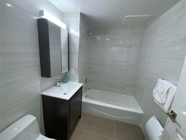 4223 Parsons Blvd Unit 1E, Flushing, NY 11355 - bathroom featuring tile patterned floors, toilet, vanity, tile walls, and bathtub / shower combination