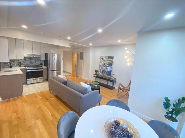 4223 Parsons Blvd Unit 1E, Flushing, NY 11355 - living room featuring light wood-style floors, baseboards, and recessed lighting
