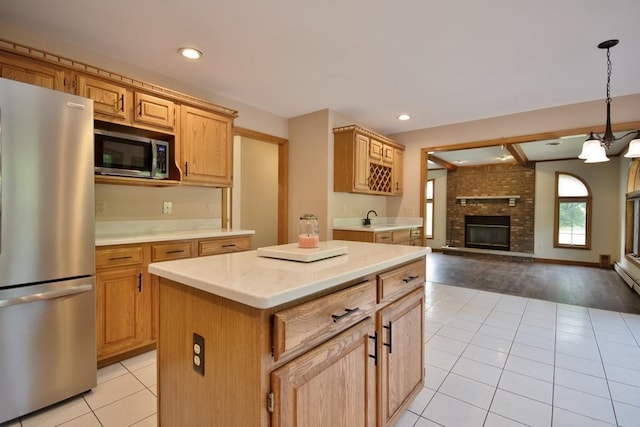 4 Andrew Ct, Florida, NY 10921 - kitchen featuring appliances with stainless steel finishes, open floor plan, light tile patterned flooring, a brick fireplace, and light countertops