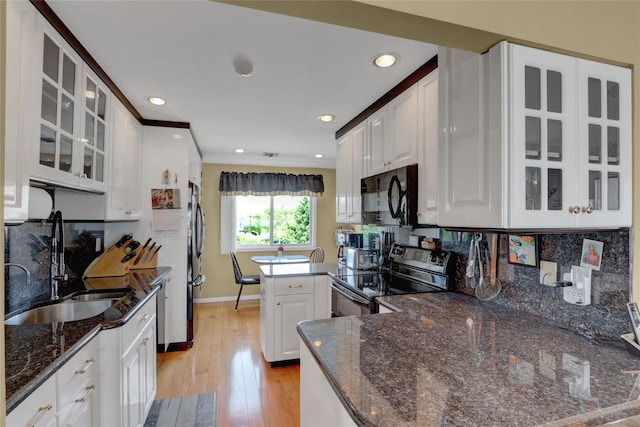 4 Waters Edge Unit 4, Shirley, NY 11967 - kitchen featuring black microwave, electric range oven, a sink, freestanding refrigerator, and white cabinetry