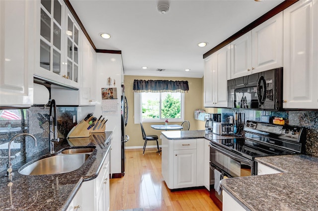 4 Waters Edge Unit 4, Shirley, NY 11967 - kitchen with black appliances, a sink, white cabinets, glass insert cabinets, and backsplash