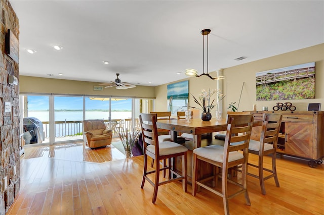 4 Waters Edge Unit 4, Shirley, NY 11967 - dining area with light wood-type flooring, ceiling fan, a water view, and recessed lighting