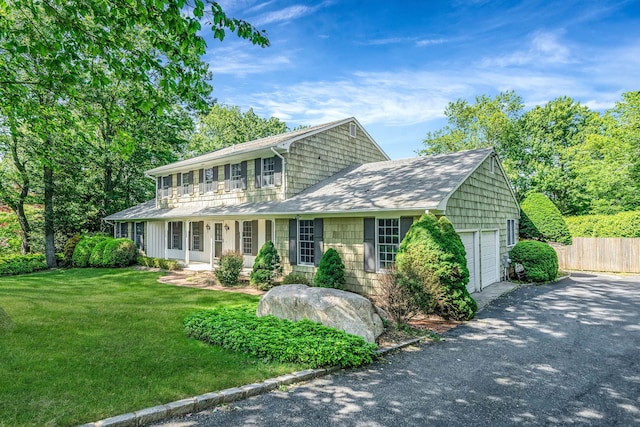 7 Sandpiper Ct, Shoreham, NY 11786 - colonial-style house with a shingled roof, asphalt driveway, covered porch, and a garage