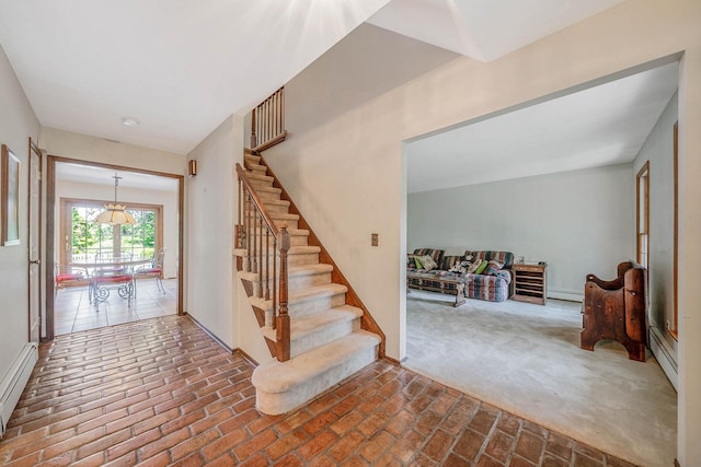 7 Sandpiper Ct, Shoreham, NY 11786 - staircase with brick floors, baseboard heating, carpet flooring, and a baseboard radiator