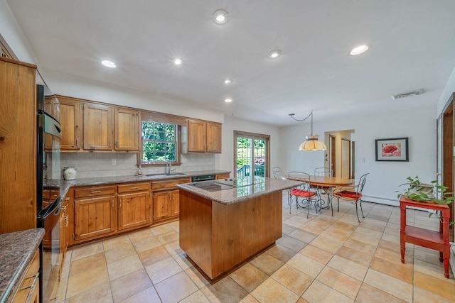 7 Sandpiper Ct, Shoreham, NY 11786 - kitchen featuring a center island, brown cabinets, decorative backsplash, a sink, and recessed lighting