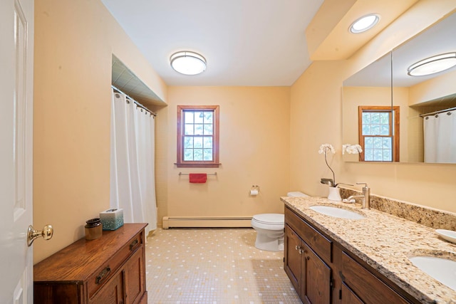 7 Sandpiper Ct, Shoreham, NY 11786 - bathroom featuring baseboard heating, double vanity, healthy amount of natural light, and toilet