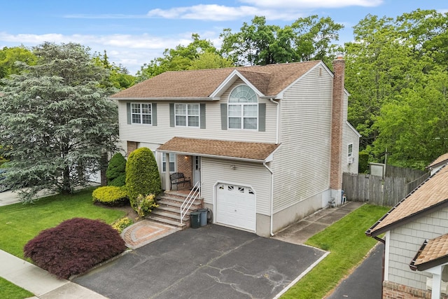 1448 Dewey Ave, North Bellmore, NY 11710 - view of front of property with driveway, an attached garage, a chimney, and roof with shingles