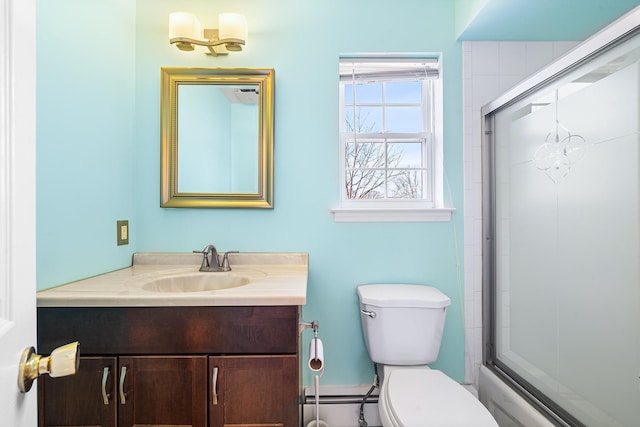 1448 Dewey Ave, North Bellmore, NY 11710 - bathroom with toilet, vanity, a baseboard radiator, and bath / shower combo with glass door
