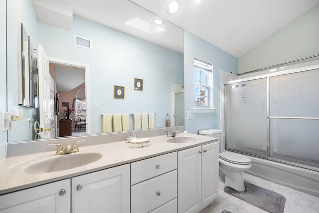 1448 Dewey Ave, North Bellmore, NY 11710 - bathroom featuring vaulted ceiling, double vanity, toilet, ensuite bathroom, and combined bath / shower with glass door