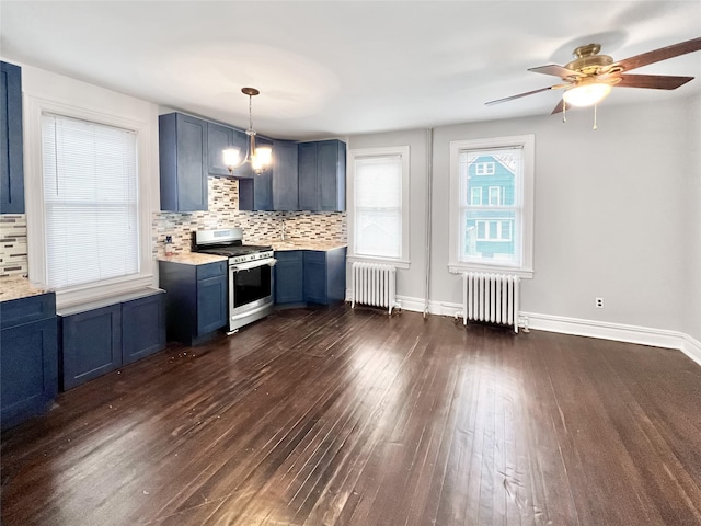 320 E 235th St, Bronx, NY 10470 - kitchen with stainless steel gas stove, radiator heating unit, blue cabinets, and light countertops