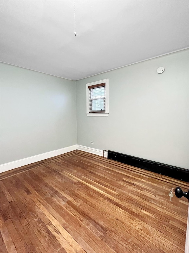 320 E 235th St, Bronx, NY 10470 - unfurnished room featuring hardwood / wood-style flooring, baseboards, and a smoke detector
