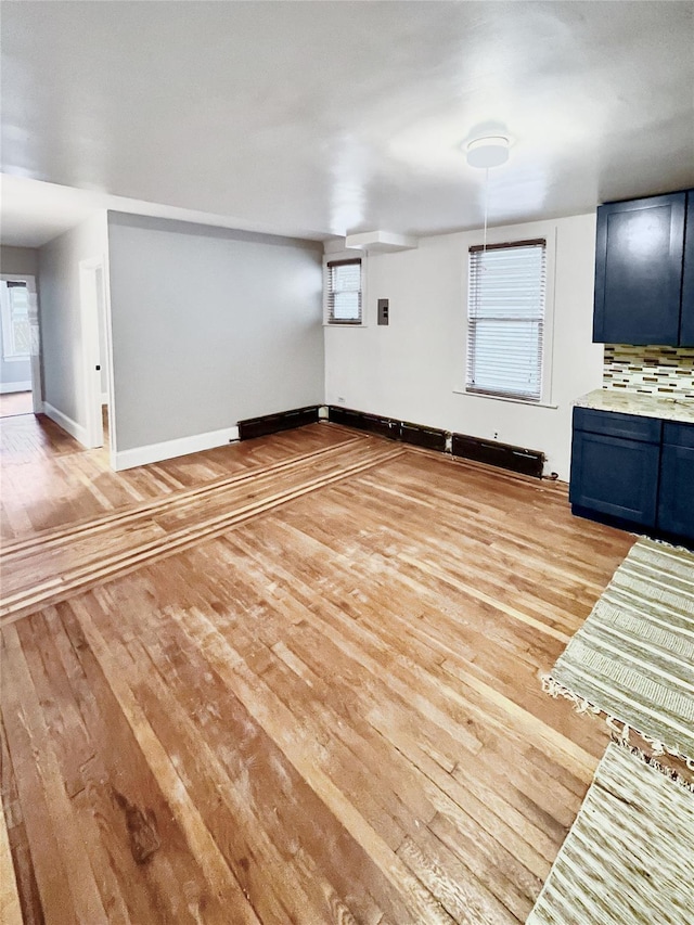 320 E 235th St, Bronx, NY 10470 - unfurnished living room featuring light wood-style flooring and baseboards