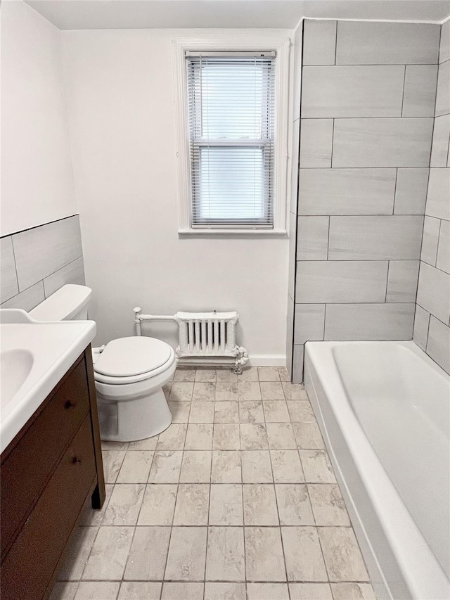 320 E 235th St, Bronx, NY 10470 - full bathroom with radiator heating unit, toilet, vanity, and baseboards