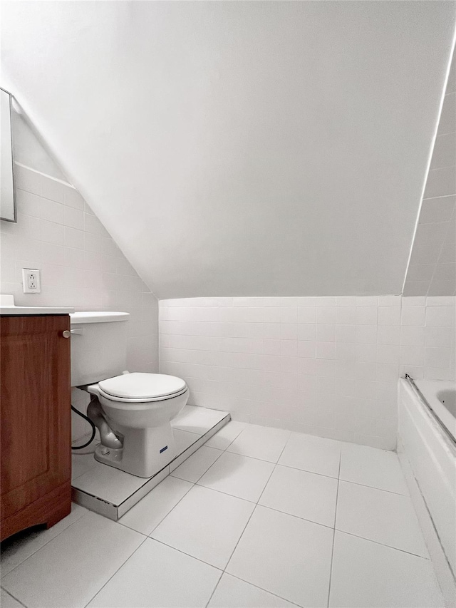 320 E 235th St, Bronx, NY 10470 - full bath with toilet, a tub, vaulted ceiling, vanity, and tile patterned flooring