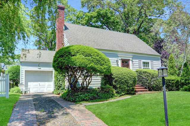 195 Loines Ave, Merrick, NY 11566 - view of front of home featuring a front lawn, a chimney, driveway, a garage, and a shingled roof