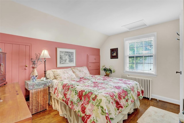 195 Loines Ave, Merrick, NY 11566 - bedroom featuring radiator heating unit, lofted ceiling, wood finished floors, attic access, and baseboards