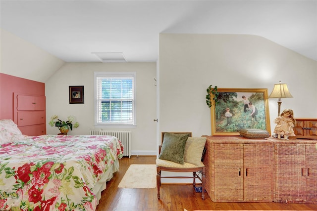 195 Loines Ave, Merrick, NY 11566 - bedroom featuring radiator, lofted ceiling, wood finished floors, and attic access
