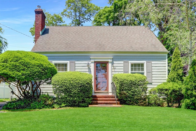 195 Loines Ave, Merrick, NY 11566 - cape cod house featuring a front lawn, a chimney, and roof with shingles