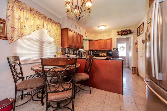 21AKA16 Larkspur Ln, Yonkers, NY 10704 - kitchen featuring freestanding refrigerator, dark countertops, brown cabinetry, a peninsula, and a chandelier