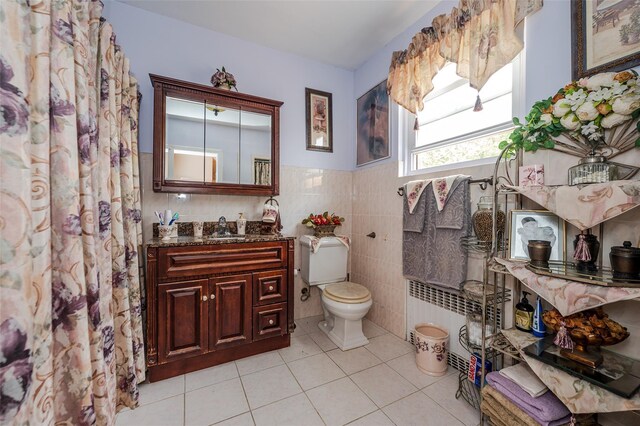 21AKA16 Larkspur Ln, Yonkers, NY 10704 - bathroom with tile patterned flooring, toilet, vanity, tile walls, and radiator heating unit