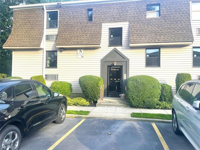 9 Everit Ave Unit A10, 11, Hewlett, NY 11557 - view of front of house featuring roof with shingles, uncovered parking, and mansard roof