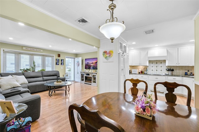 56 15th Ave, West Babylon, NY 11704 - dining room with light wood finished floors, crown molding, and recessed lighting