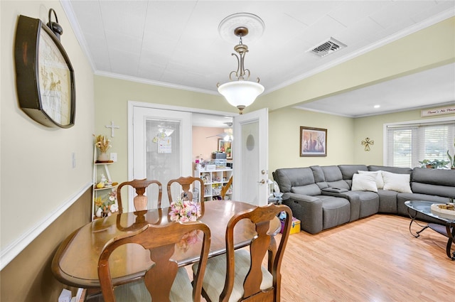 56 15th Ave, West Babylon, NY 11704 - dining room featuring crown molding and light wood-style flooring