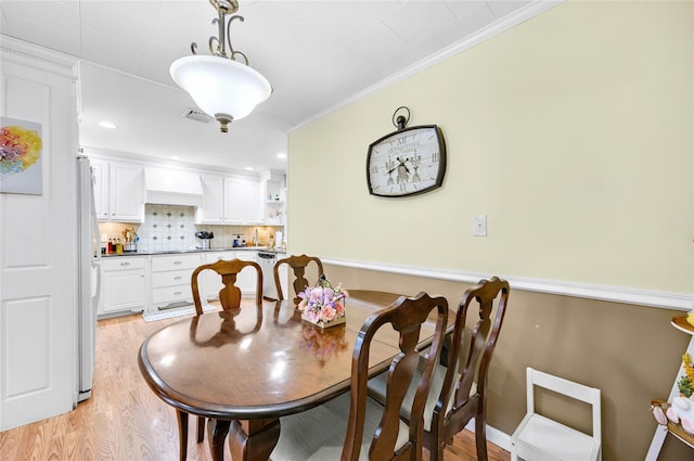 56 15th Ave, West Babylon, NY 11704 - dining space featuring light wood-type flooring and ornamental molding
