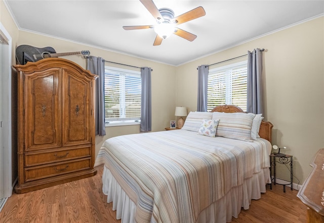 56 15th Ave, West Babylon, NY 11704 - bedroom with multiple windows, light wood-style flooring, ceiling fan, and crown molding
