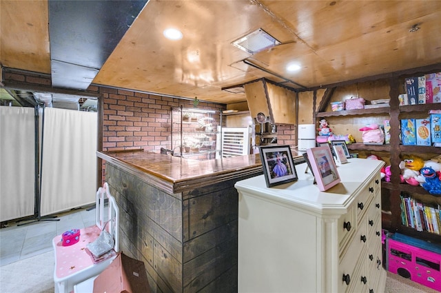 56 15th Ave, West Babylon, NY 11704 - kitchen featuring brick wall, white cabinets, and recessed lighting