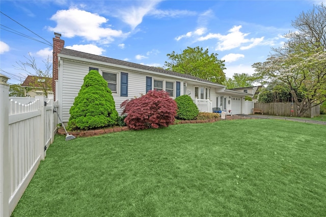 56 15th Ave, West Babylon, NY 11704 - view of front of property with a chimney, a garage, and driveway