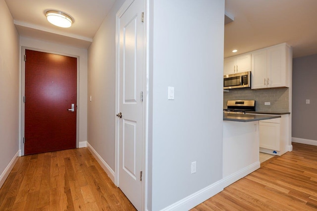 661 W Broadway Unit 204, Long Beach, NY 11561 - hall featuring light wood-type flooring, baseboards, and recessed lighting