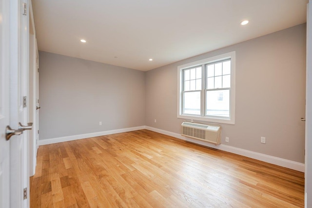 661 W Broadway Unit 204, Long Beach, NY 11561 - spare room with a wall mounted AC, light wood-type flooring, baseboards, and recessed lighting