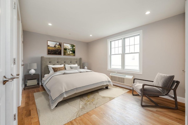 661 W Broadway Unit 204, Long Beach, NY 11561 - bedroom featuring light wood finished floors, a wall mounted air conditioner, recessed lighting, and baseboards