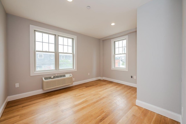 661 W Broadway Unit 204, Long Beach, NY 11561 - spare room with a wall mounted air conditioner, light wood-style floors, baseboards, and recessed lighting