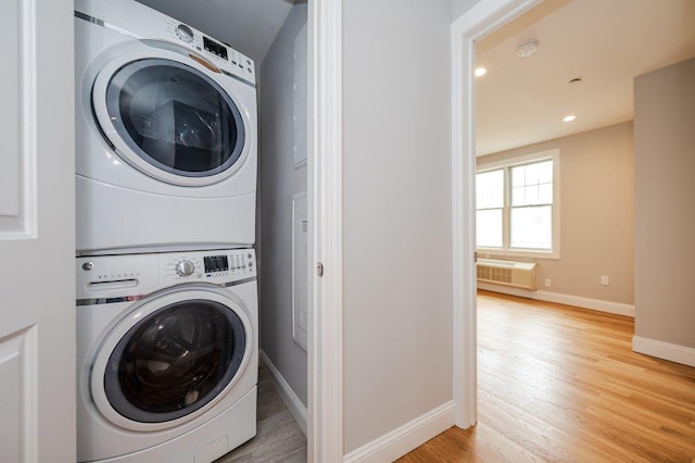 661 W Broadway Unit 204, Long Beach, NY 11561 - washroom featuring estacked washer and dryer, baseboards, wood finished floors, a wall mounted AC, and recessed lighting