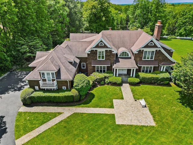 61 Carolyn Pl, Chappaqua, NY 10514 - shingle-style home with a chimney, a front lawn, and a wooded view