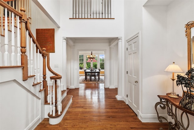 61 Carolyn Pl, Chappaqua, NY 10514 - foyer entrance featuring wood finished floors, baseboards, a chandelier, stairs, and a towering ceiling