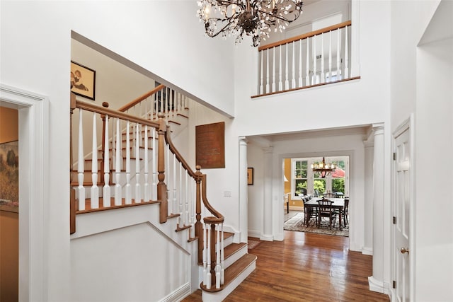 61 Carolyn Pl, Chappaqua, NY 10514 - foyer featuring a chandelier, wood finished floors, stairs, baseboards, and a towering ceiling