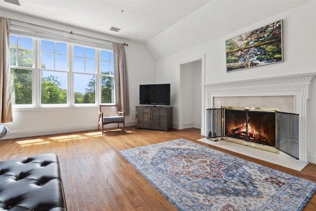 61 Carolyn Pl, Chappaqua, NY 10514 - living room with vaulted ceiling, a fireplace with flush hearth, baseboards, and wood finished floors