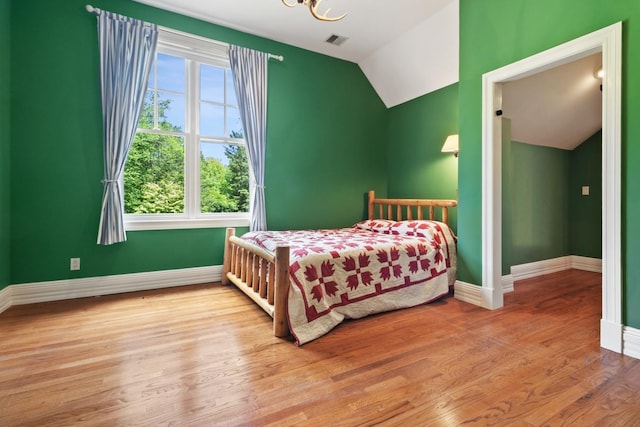 61 Carolyn Pl, Chappaqua, NY 10514 - bedroom with vaulted ceiling, baseboards, wood finished floors, and a chandelier