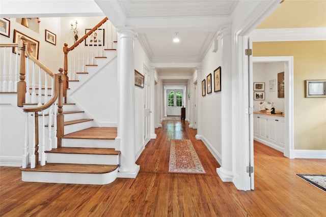 61 Carolyn Pl, Chappaqua, NY 10514 - foyer with wood finished floors, ornamental molding, stairway, baseboards, and decorative columns