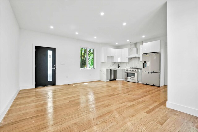 76-17 162nd St, Fresh Meadows, NY 11366 - unfurnished living room featuring recessed lighting, light wood-style floors, and baseboards