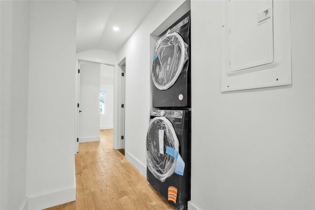 76-17 162nd St, Fresh Meadows, NY 11366 - washroom featuring stacked washer / drying machine, electric panel, baseboards, light wood finished floors, and recessed lighting