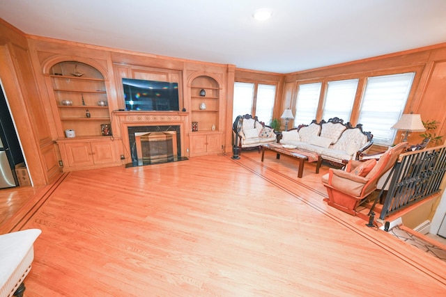 165 Page Rd, Valley Stream, NY 11581 - living room with a fireplace, light wood-style floors, and built in shelves