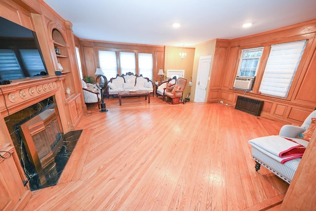 165 Page Rd, Valley Stream, NY 11581 - living area featuring a fireplace, wood finished floors, radiator heating unit, cooling unit, and recessed lighting